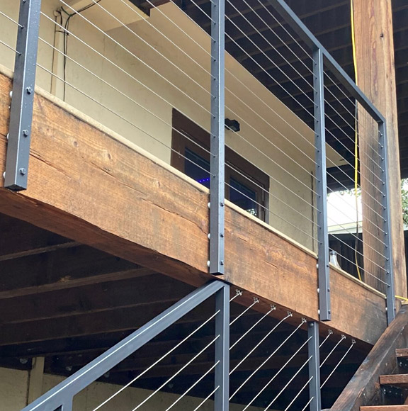 Steel cable railings installed on property with stairs